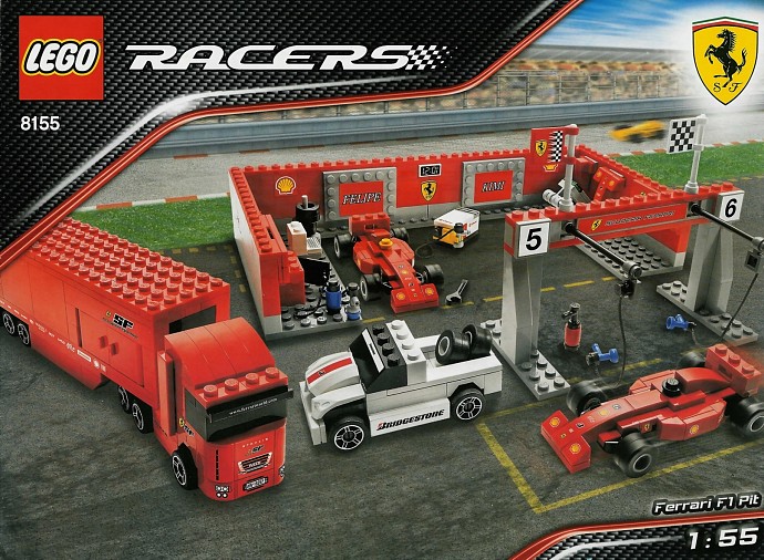 Original Ferrari F1 Pit box showing the garage, two red race cars and support vehicles